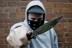 A masked thug wielding a blade